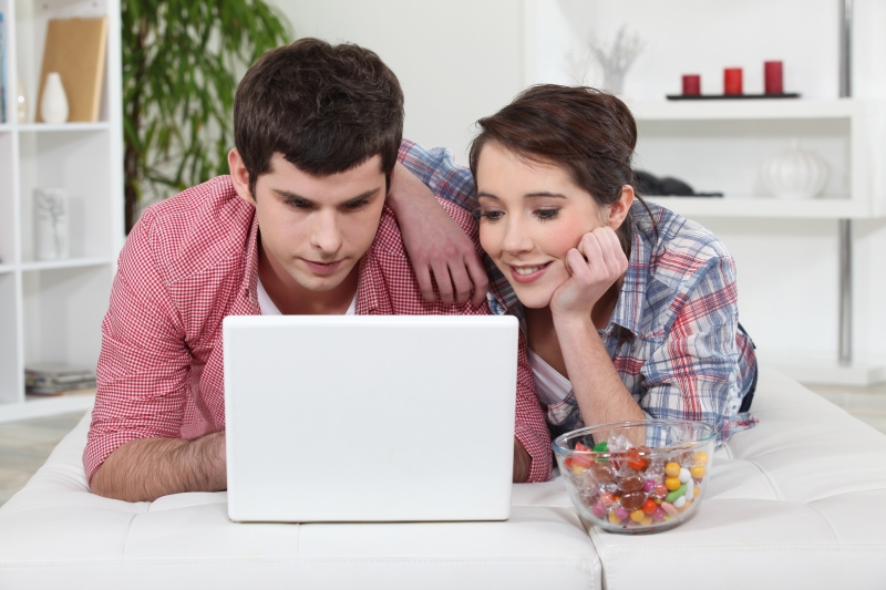 -young-couple-watching-a-film-on-their-laptop